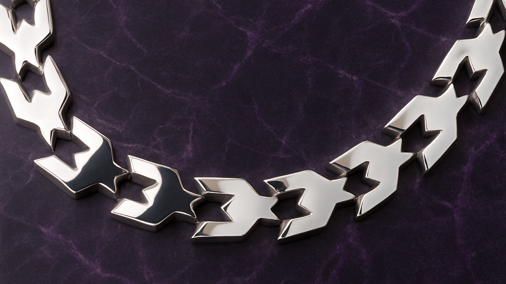 Silver chain necklace on a purple textured background