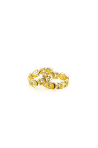 Gold chain-style ring on a white background