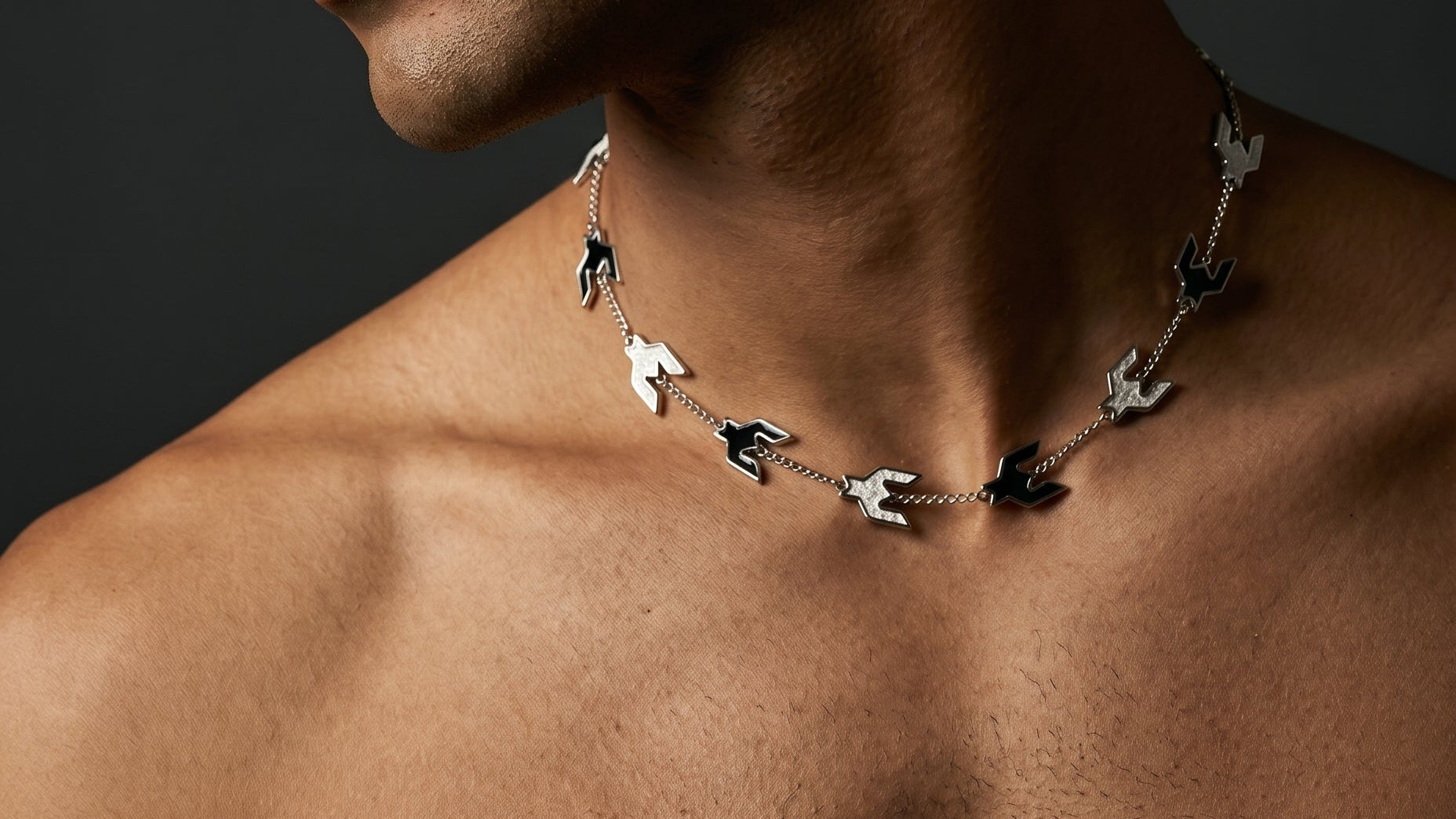 Man wearing a necklace with dark background